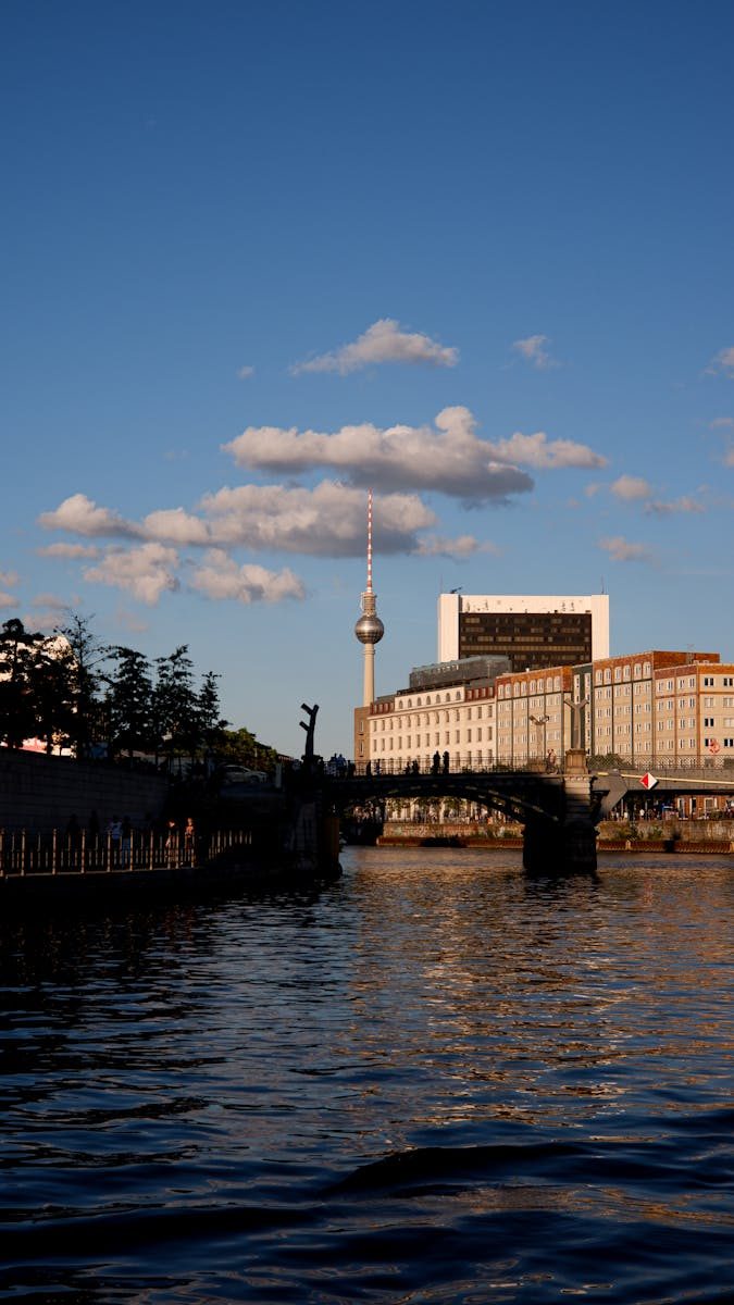 Stunning view of Berlin with TV Tower at sunset reflecting on the river.
